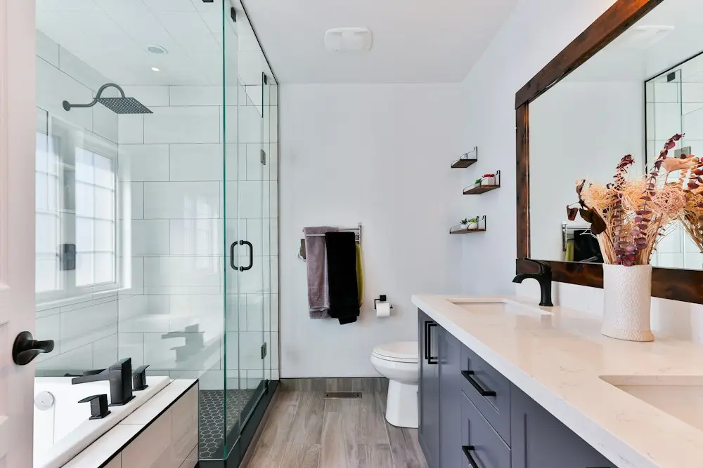 A bathroom with a shower, tub and vanity