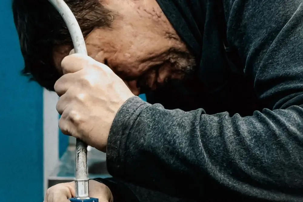 A technician feeding an inspection cable into a line
