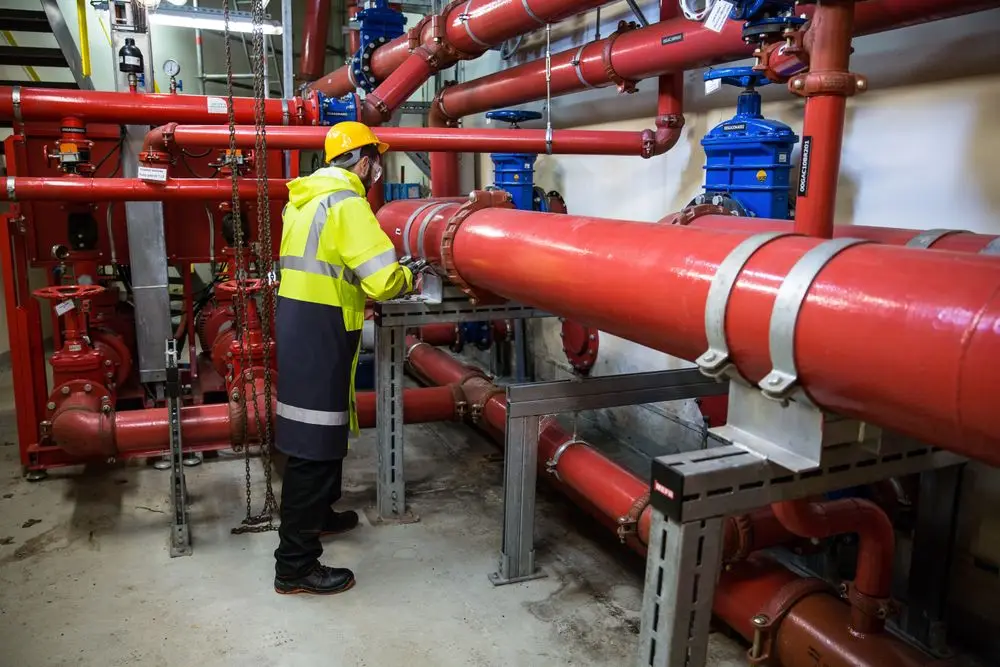 A commercial plant room with large red pipework