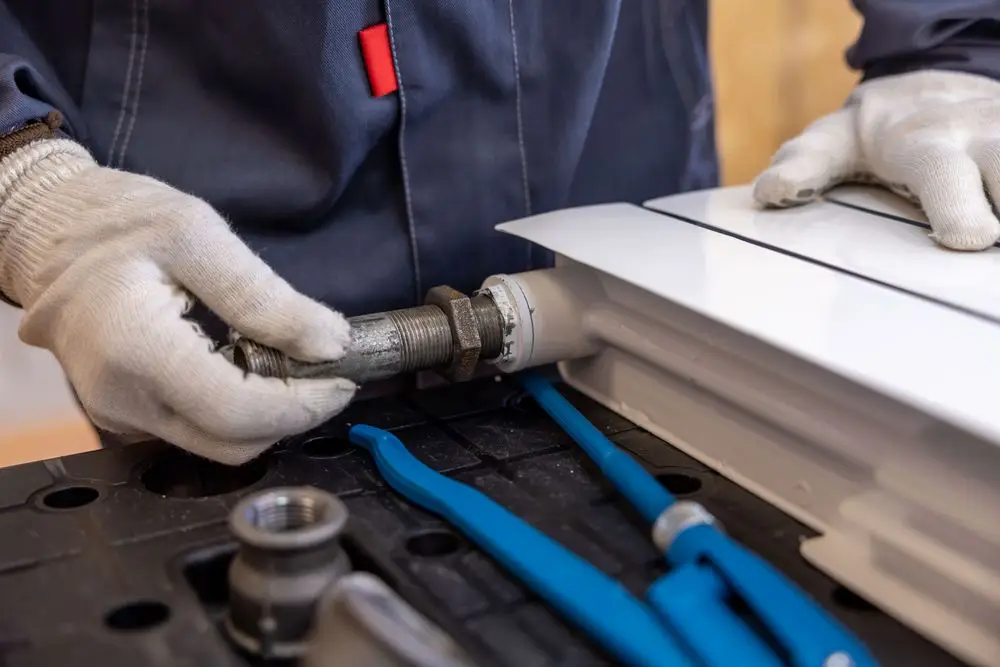 Hands assembling floor-level pipe fittings